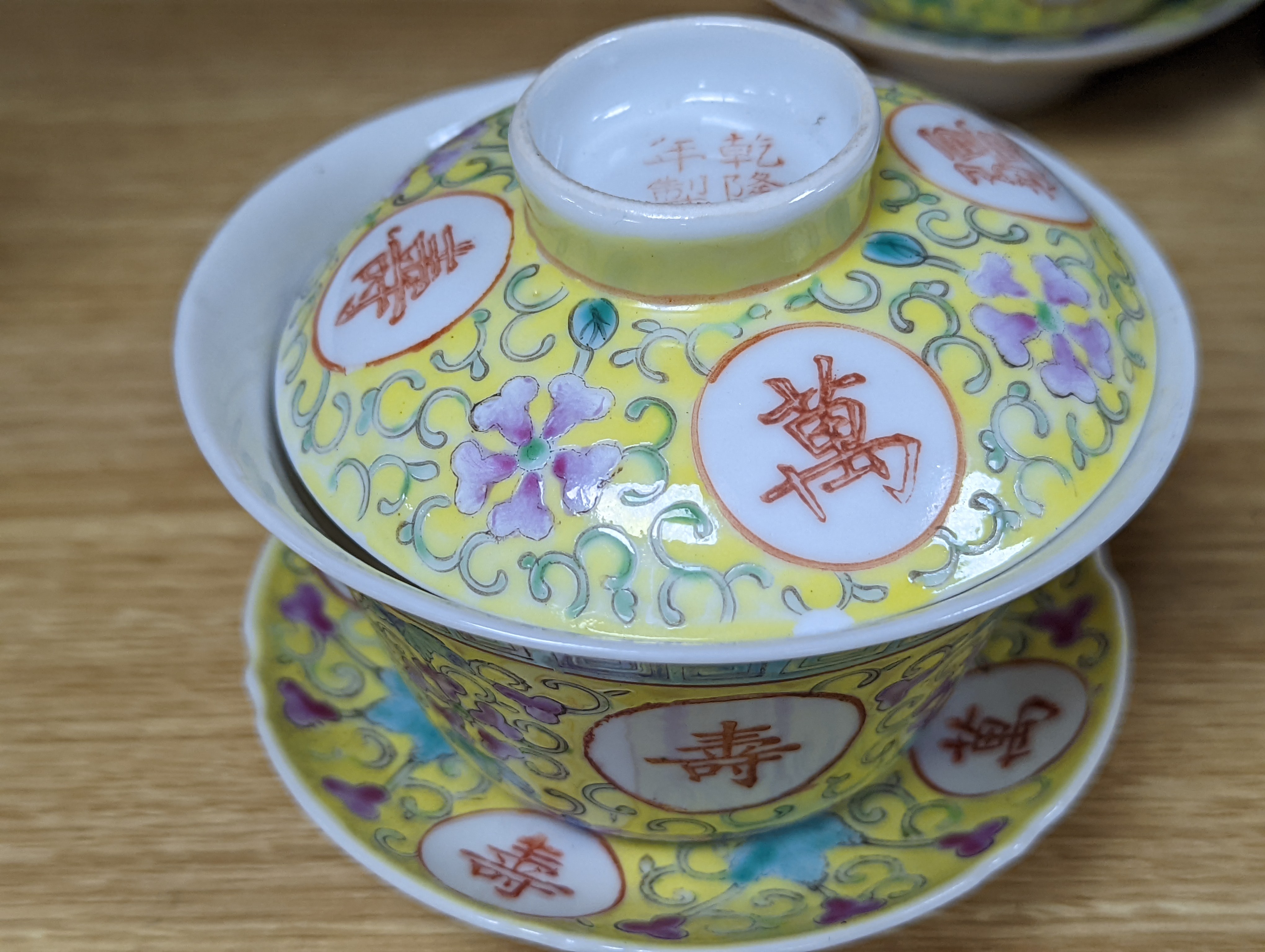 A pair of Chinese enamelled porcelain rice bowls, covers and stands and an odd bowl